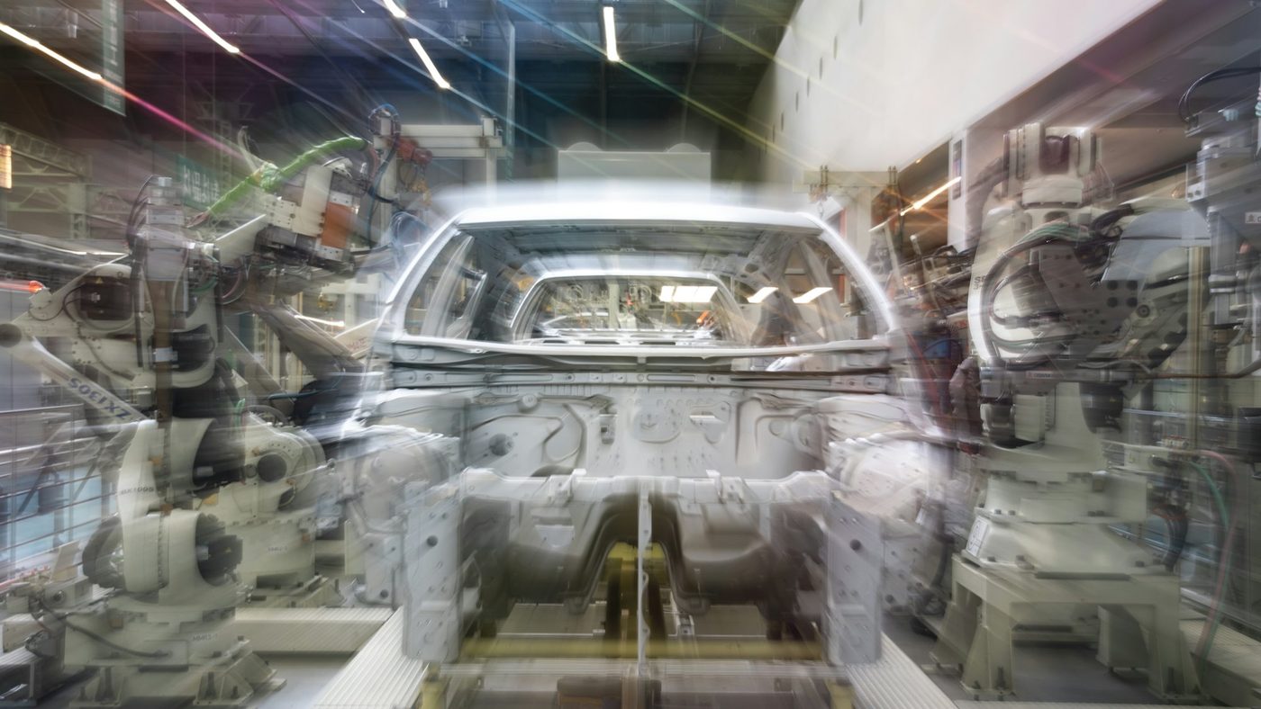 Robotic arms assembling a car body on an automotive production line