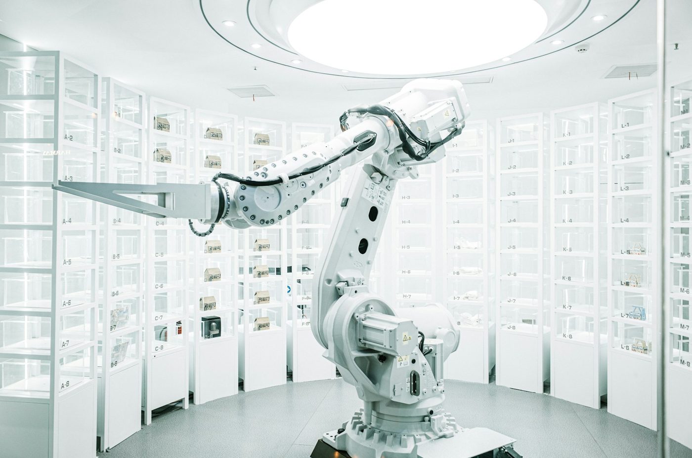 White robotic arm on a stand in a clean showroom