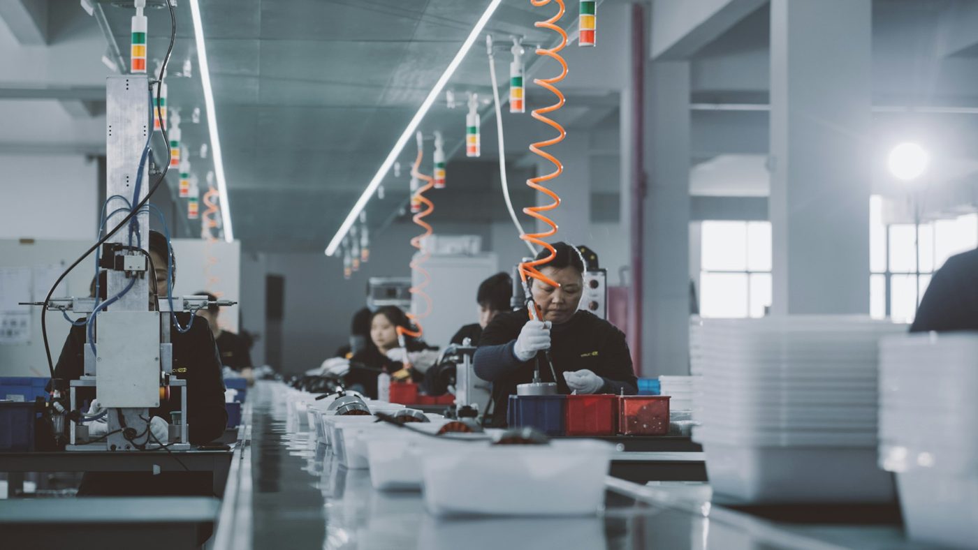 Workers on an electronics assembly line