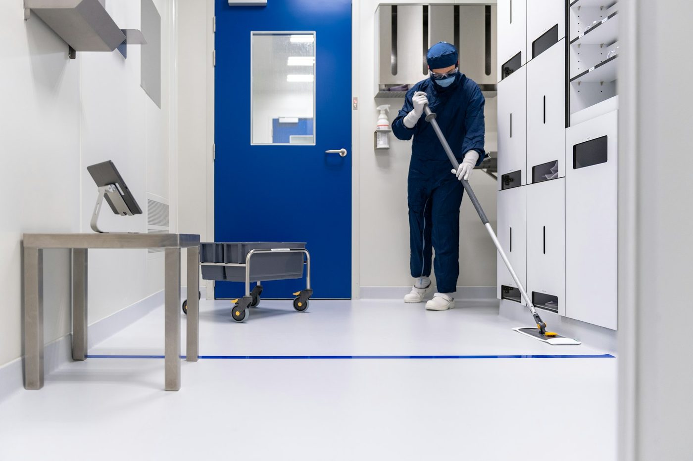 Technician in protective clothing inside a clean room