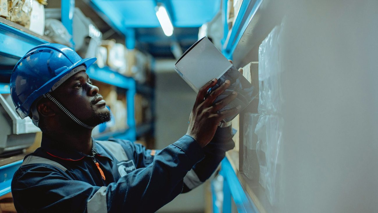 Warehouse worker checking stock against a document
